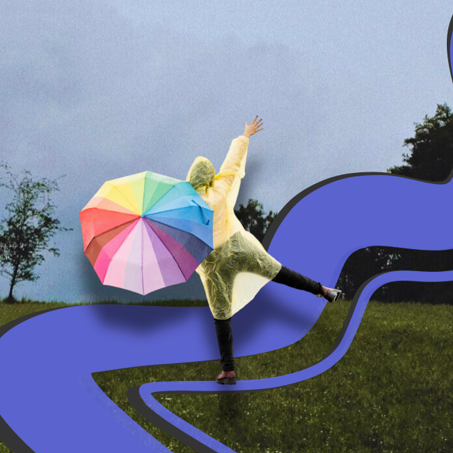 Grått väder, en person med regnbågsfärgat paraply gör ett hopp